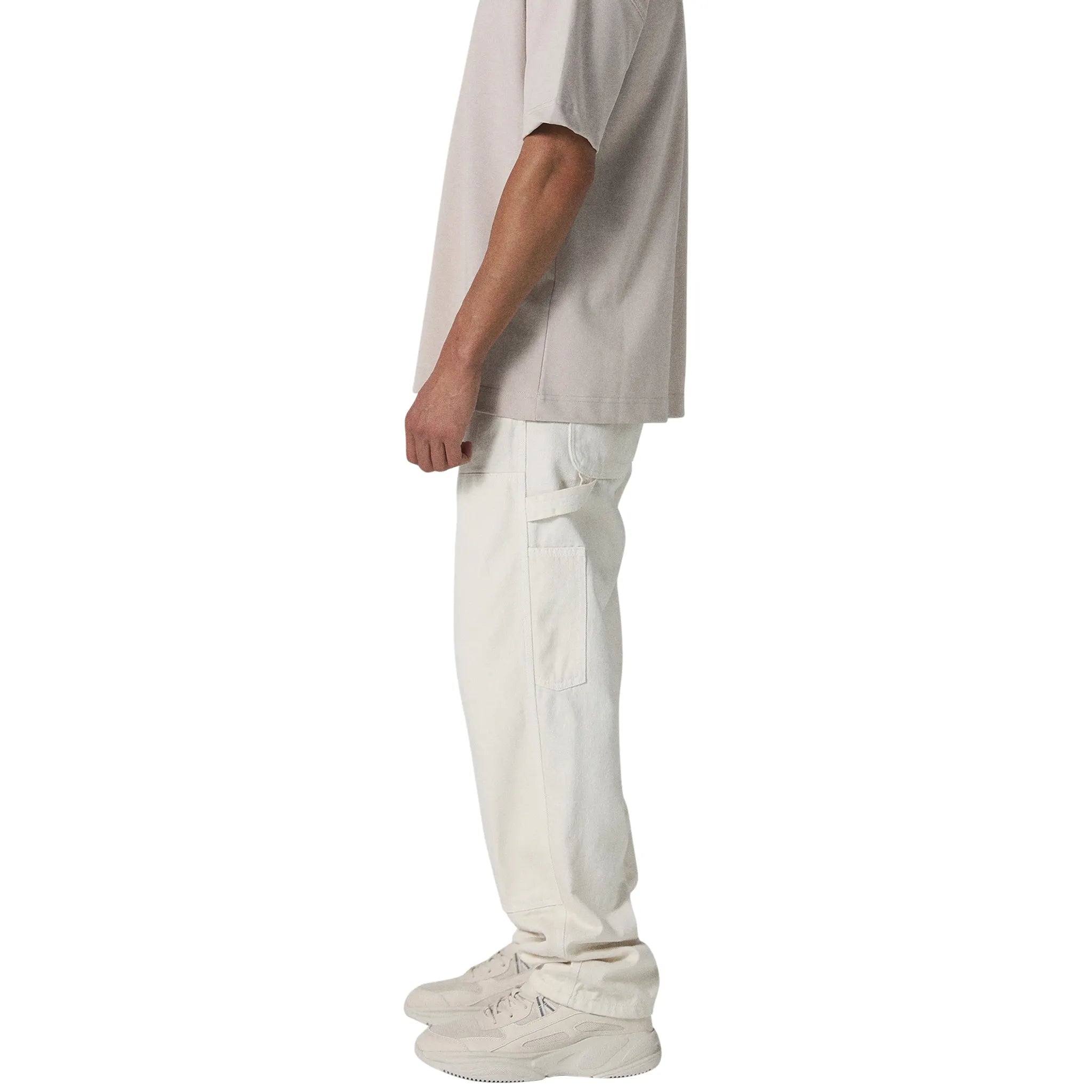 Model side view of Human Race Genetics Ecru Carpenter Jeans